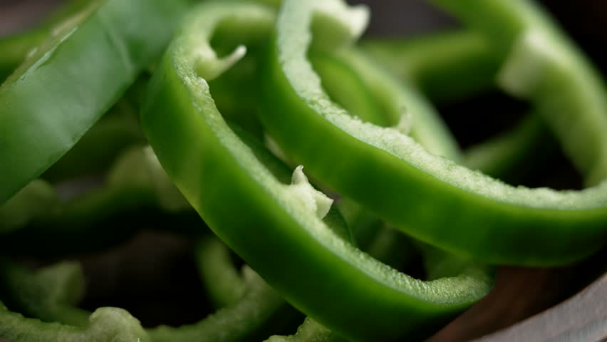 Sliced farm grown green bell pepper close up. Bio vegetable healthy ingredient. Rotation