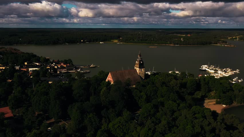 Aerial tracking shot of the church and old town Naantali harbor, summer in Finland
