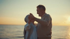 Portrait happy senior family wife husband looking camera smiling dancing on sea beach at sunny weather. Old man hugging dancing with woman. Love pleasant relationships, lifelong marriage concept. - Powered by Shutterstock - Get 15% off with code: PIKWIZARD15