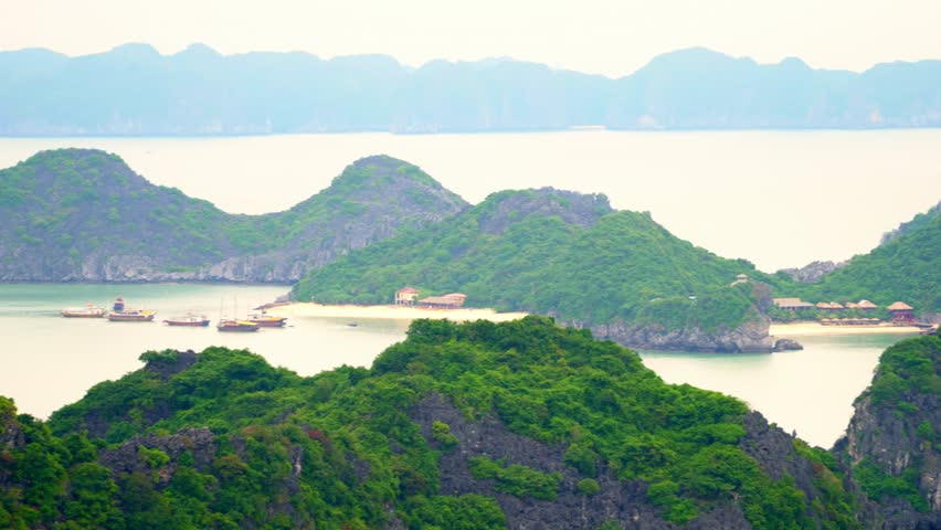 eautiful open spaces of a green bay. The gulf in Vietnam. Beautiful traditional boats in a bay at the island. Open spaces of Vietnam. Islands of Cat Ba.