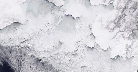 Very high-altitude overflight aerial of ice sheets and sea ice, northern Bering Sea coast. Clip loops and is reversible. Elements of this image furnished by NASA