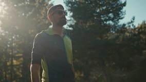 Proud happy smiling Caucasian male man runner sportsman bodybuilder looking smart watch device checking result jogging running sunlight sunrise outside nature park sport achievement ready to run relax - Powered by Shutterstock - Get 15% off with code: PIKWIZARD15