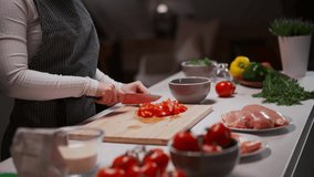 Closeup of the chef woman cooking food cutting tomato preparing vegetables with knife - Powered by Shutterstock - Get 15% off with code: PIKWIZARD15