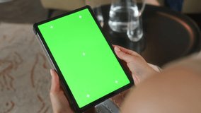 Female psychologist is holding tablet with green screen and chroma key motion trackers, in his hands. Woman is using app online on pad, touching screen to take notes during family therapy. - Powered by Shutterstock - Get 15% off with code: PIKWIZARD15