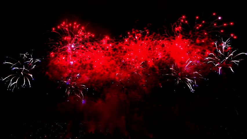 A red fireworks display illuminates the night sky, creating a spectacular burst of color and light Royalty-Free Stock Footage #3486165861
