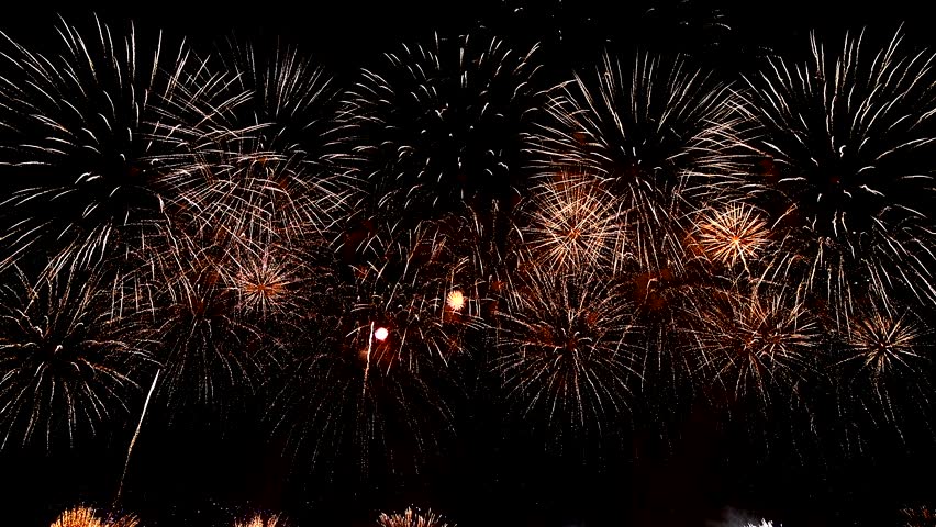 Watch as a collection of fireworks illuminate the dark night sky with a dazzling array of colors and patterns Royalty-Free Stock Footage #3486173553