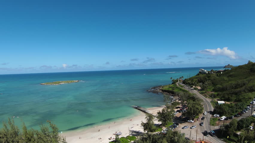 2.5x Slow motion drone aerial view from Kailua Beach Park to Lanikai Beach and Mokulua Islands on a clear day