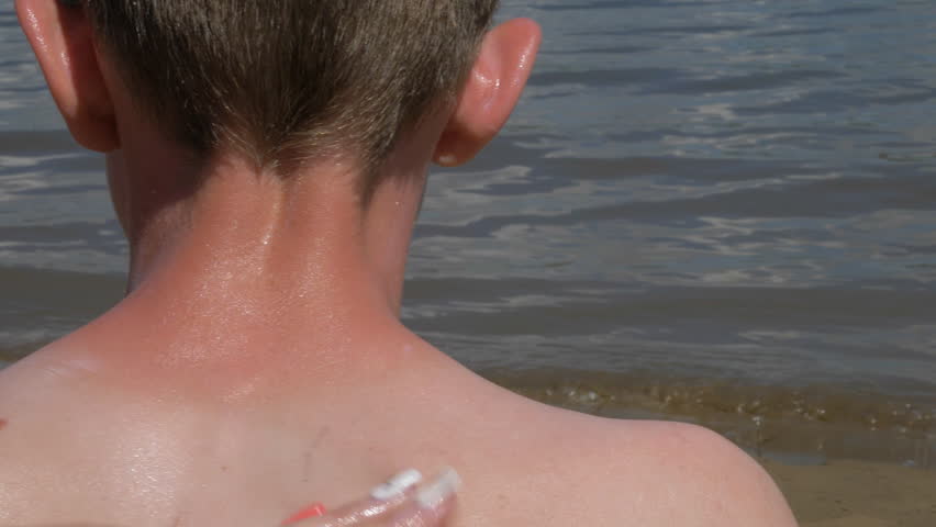 The boy apply sunscreen to face and body. Parents put sunscreen on her daughter's neck. Royalty-Free Stock Footage #34862266
