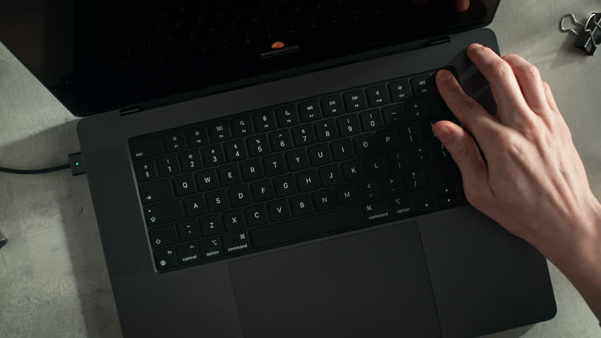 Laptop User Opens the Device, Plugged into Power, and Unlocks It Using the Built-in Fingerprint Scanner, Dolly in - Powered by Shutterstock - Get 15% off with code: PIKWIZARD15