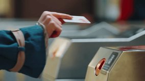 Close-up slow motion passengers going through tourniquet to subway platform. Entrance to railway or bus station, automatic ticket scanner turnstile. Female hand swipe card to pay public transport - Powered by Shutterstock - Get 15% off with code: PIKWIZARD15