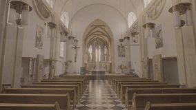 Moving backwards through aisle from altar in empty church. Christian cathedral interior with wooden pews rows, sanctuary and black and white tile floor wide shot - Powered by Shutterstock - Get 15% off with code: PIKWIZARD15