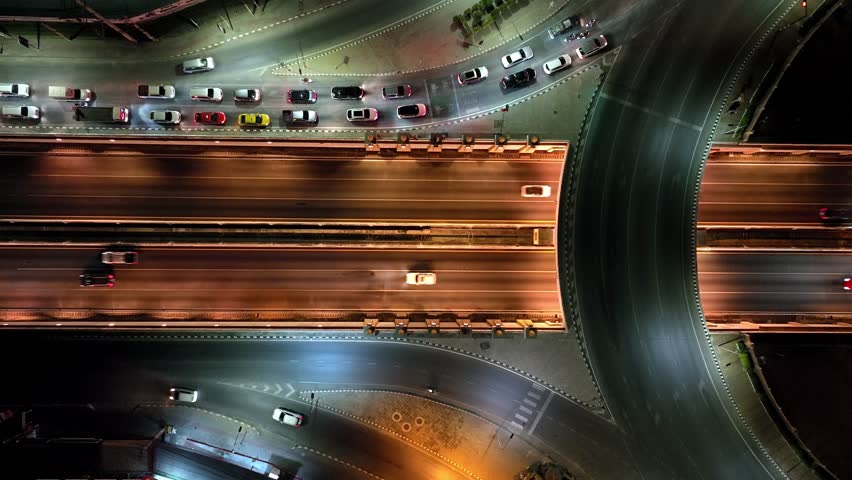 Beautiful top view time-lapse of car traffic at roundabout lane and buildings. drone aerial expressway. Urban cityscape concept or abstract of advanced innovation, financial technology, energy power Royalty-Free Stock Footage #3486294793