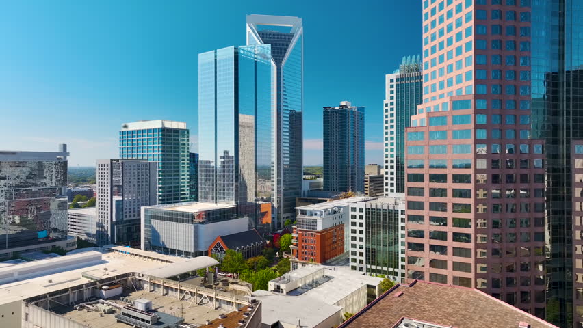 Downtown district of Charlotte city in North Carolina, USA. Glass and steel high skyscraper buildings in modern American midtown