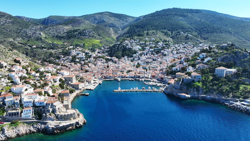 Aerial drone cinematic video of picturesque and historic main village of Hydra or Ydra island well know for captain's mansions and marine tradition, Saronic gulf, Greece