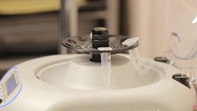 Scientist inserting plastic test tubes in centrifuge apparatus and starting process of separating components. Modern laboratory machine blending substances in containers while rotating. - Powered by Shutterstock - Get 15% off with code: PIKWIZARD15