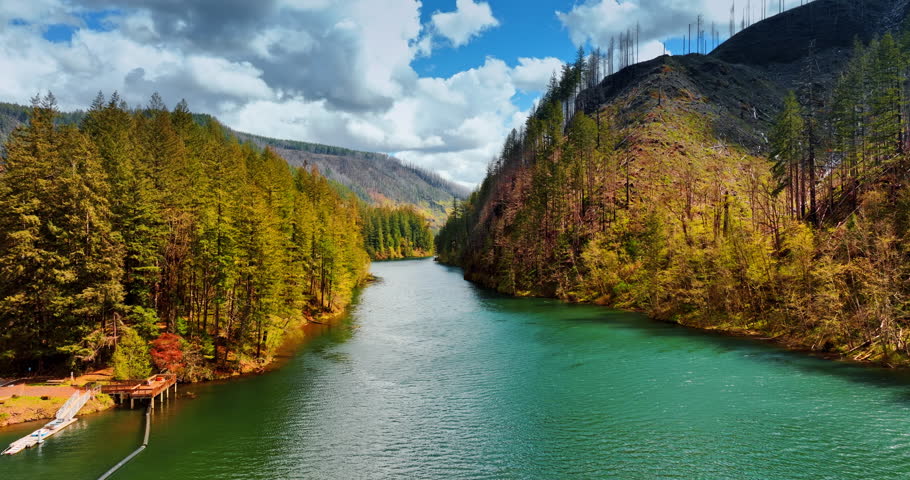 Going up over the river in mountains with sea-blue water. Scenic view on the rocky landscape in Oregon State, the USA on sunny daytime. Mt. Hood National Forest.