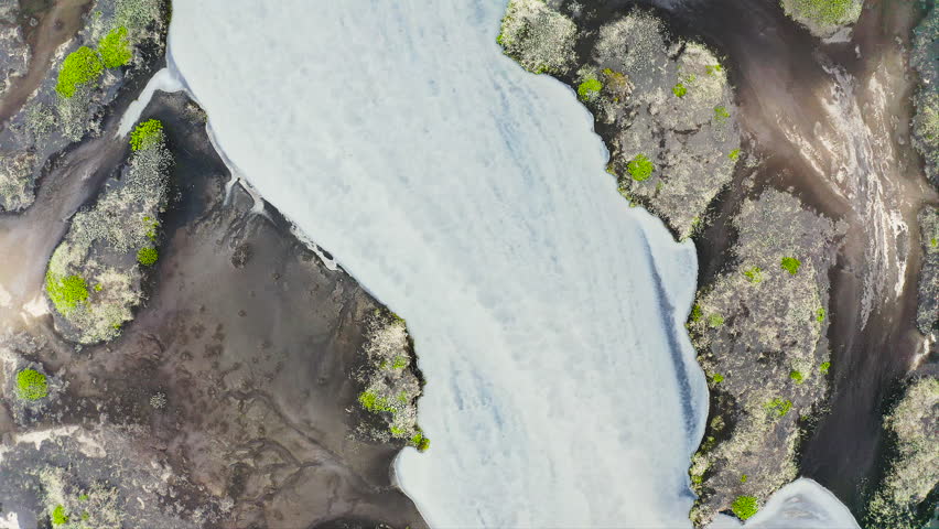 Aerial view of the torrents of water from the melting of the Fjallsjokull glacier, on its way to the sea, in southeast Iceland.