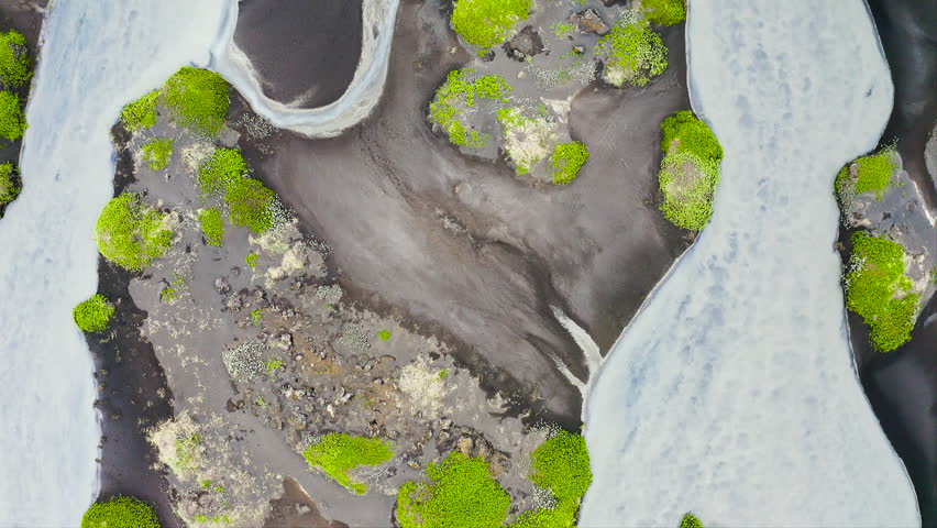 Aerial view of the torrents of water from the melting of the Fjallsjokull glacier, on its way to the sea, in southeast Iceland.