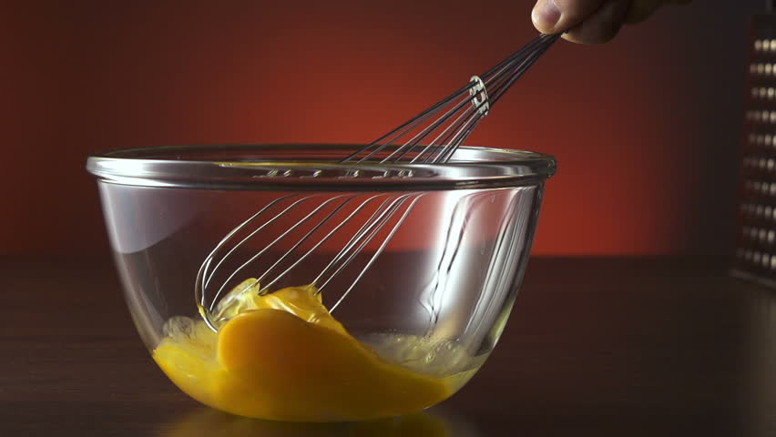 Eggs being beaten and stirred in bowl