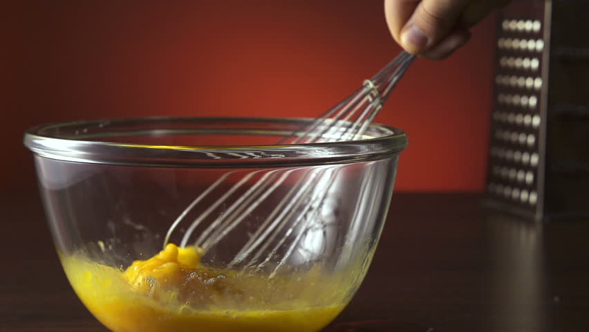 Eggs being beaten and stirred in bowl