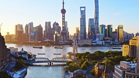 Aerial view of Shanghai city buildings and skyscrapers scenery at sunrise. Famous city landmarks in China. Drone ascending to shoot. - Powered by Shutterstock - Get 15% off with code: PIKWIZARD15