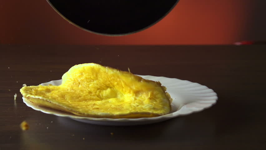 Putting the omelet on a plate slow motion 250fps