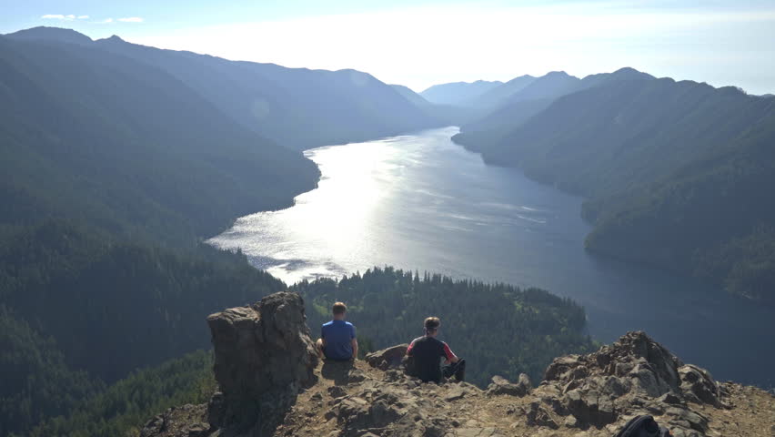Two friends enjoy view on Mount Storm King near Olympic National Park