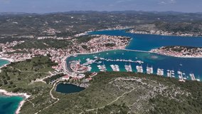 Aerial panoramic video of Rogoznica turquoise bay town and marina, central Dalmatia region of Croatia.