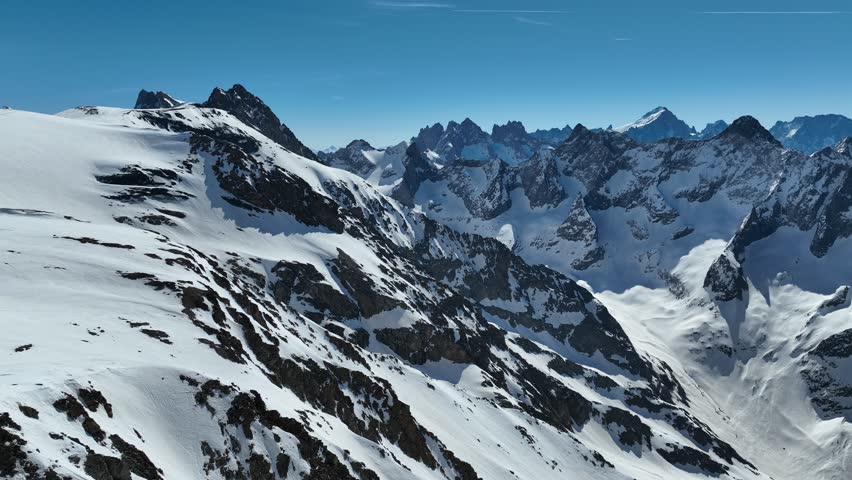Aerial drone view of  French Alps Mountains glacier near Grenoble. Europe alps in winter. Les deux alpes resort. Winter mountains beautiful alpine panoramic. Mountains aerial snow winter view.