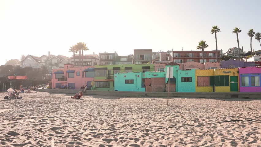 A view of the colorful row of buildings on the shore of Capitola Beach in Capitola, California on a spring day.