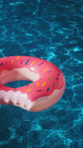 Pink inflatable ring in the water of a swimming pool on a sunny day. Summer holiday concept. Donut shaped inflatable ring
 Royalty-Free Stock Footage #3486929343