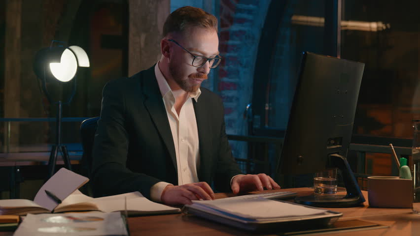 Caucasian businessman office worker employer business man guy male entrepreneur working with computer at dark night evening overtime workplace tired exhausted typing pc online job deadline busy work Royalty-Free Stock Footage #3486987519