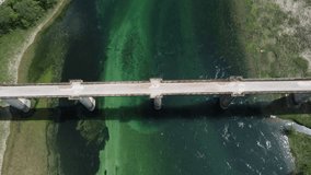 Drone 4k video of bridge over beautiful green river