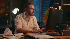 Caucasian business man at night office evening overtime overworked deadline businessman male worker guy throw sticky notes many lot of tasks on computer monitor holding head stress overload burnout - Powered by Shutterstock - Get 15% off with code: PIKWIZARD15