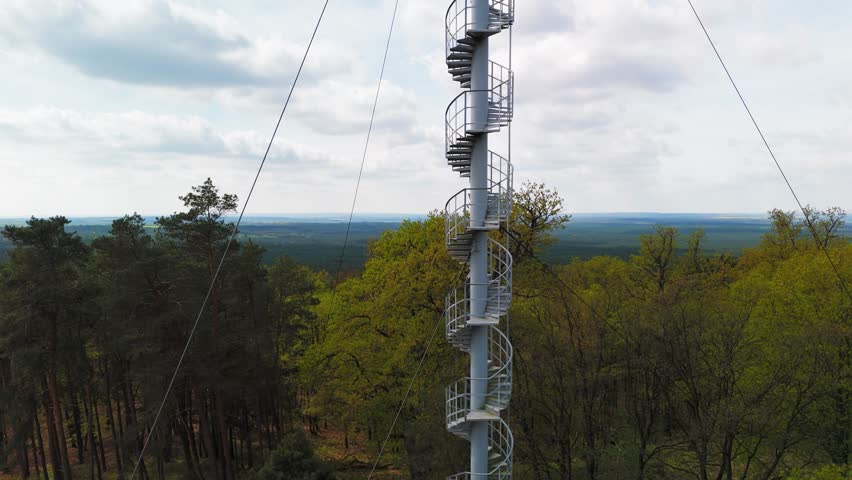 Iron stairs are leading up to the old fire tower. Aerial view.