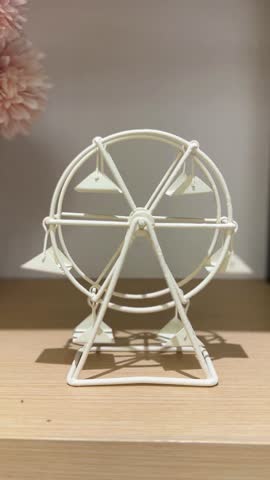 An elegant white Ferris wheel model as a chic and modern interior design element, creating a whimsical decorative accent