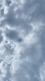 Thick clouds blue sky vertical video
