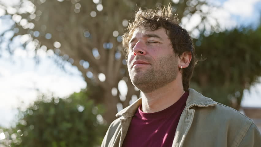 Contemplative man enjoying peaceful outdoors in park