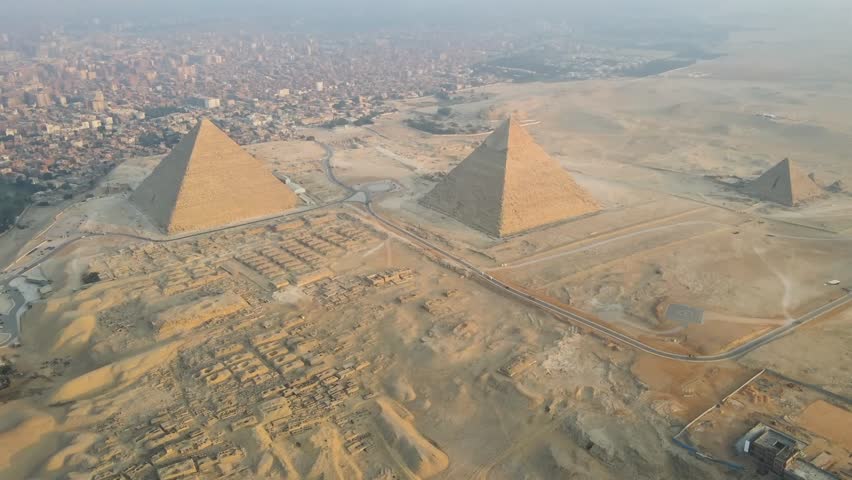 The Great Pyramids of Giza, the Pyramids Plateau, and the Sphinx in Egypt offer a profound sense of awe and wonder, representing the enduring legacy of ancient civilizations and human ingenuity. Royalty-Free Stock Footage #3487114243
