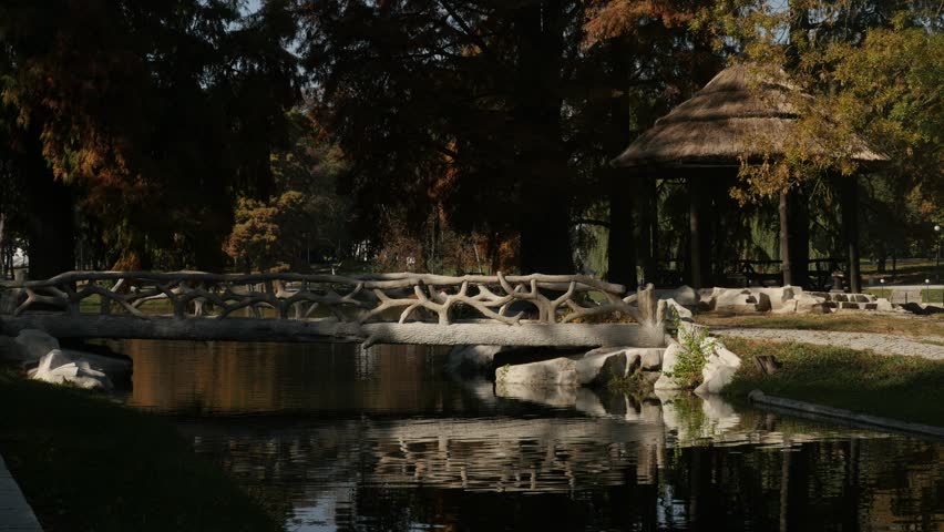 Bridge and lake of park by autumn 3840X2160 UltraHD footage - Colorful trees in Romanian city of Craiova 4K 2160p 30fps UHD video