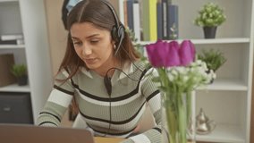 Smiling hispanic woman with headphones using laptop at home