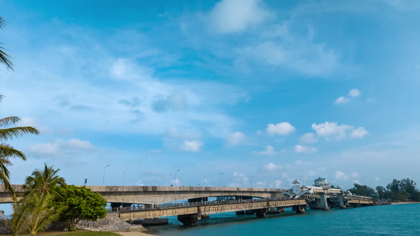 Time lapse blue sea White cloud in blue sky above Sarasin bridge viewpoint. Sarasin bridge is an important route connecting by land.
Sarasin bridge connect Phuket island to Phang Nga province.
 Royalty-Free Stock Footage #3487148177