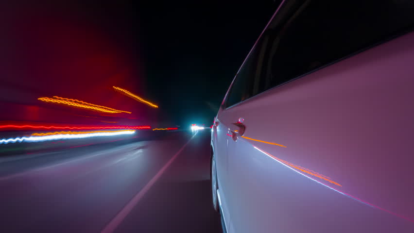 Taxi cab point of view time lapse or hyperlapse through night city. North America and Canada. Vehicle outside shot left driverside view from the back door. Long exposure timelapse of city traffic.