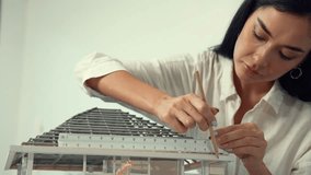 Professional young beautiful architect engineer using ruler and pencil measuring model roof length at modern office with blueprint pinned behind. Creative design and living concept. Immaculate. - Powered by Shutterstock - Get 15% off with code: PIKWIZARD15