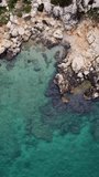 Aerial drone captures turquoise, coastline at Mersin, Turkey. Footage highlights rocky sea shore and turquoise, coastline. Explore the serene turquoise, coastline with calm blue waters