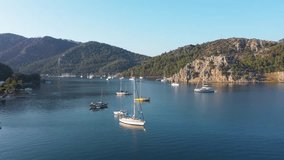 Flyover of sailing yacht and excursion boats, takes a swimming break in Kızkumu Bay in Orhaniye. A bay with turquoise blue water and pleasure boats on sea in summer time. Marmaris, Muğla, Turkey
 - Powered by Shutterstock - Get 15% off with code: PIKWIZARD15
