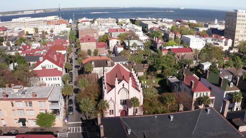 Low push-in aerial shot of the ornate French Huguenot Church in Charleston, South Carolina. 4K