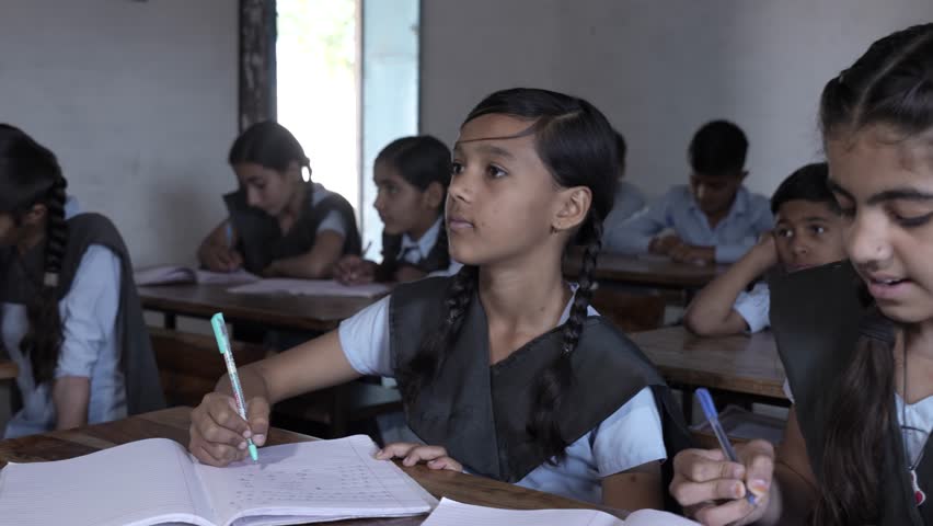 Rural Indian school students study in classroom. Elementary boys and girls writing doing classwork, test or exams, Education in india, Knowledge concept, 