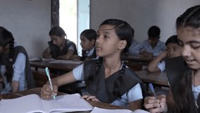 Rural Indian school students study in classroom. Elementary boys and girls writing doing classwork, test or exams, Education in india, Knowledge concept,  - Powered by Shutterstock - Get 15% off with code: PIKWIZARD15