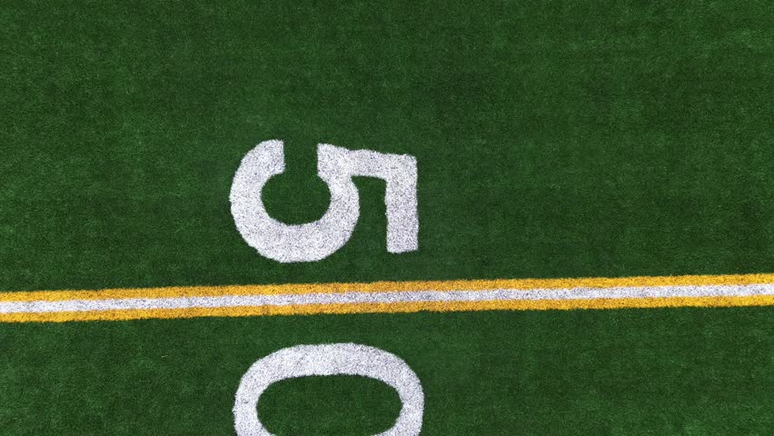 Pan Down and Rocket View of Turf Football Field from the Fifty Yard Line Royalty-Free Stock Footage #3487402179